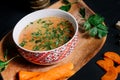 Details of traditional chicken soup in bowl and wooden board