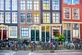 Details of a traditional old street in Amsterdam - old tilted houses, windows, doors and many parked bicycles. Historical