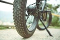 Details of a tubeless electric mountain bike tire wheel, standing on the the road trail. View from below. Low viewing