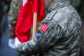 Details of a Turkish army soldier holding a flag and having Turkey and NATO insignia. Turkey and NATO relationship