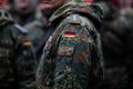 Details with the uniform and the flag on it of a German soldier taking part at the Romanian National Day military parade