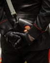 Details with the uniform and leather handbag, with a carabinier`s cap badge, of an Italian policeman in a ceremonial uniform with