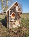 Wild bee house with many holes. Wooden insect hotel Royalty Free Stock Photo