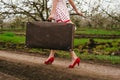 Details of woman holding retro suitcase Royalty Free Stock Photo