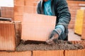 Details of worker hands laying bricks, putty knife, spatula and brick mortar Royalty Free Stock Photo