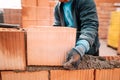 Details of worker hands laying bricks, putty knife, spatula and brick mortar Royalty Free Stock Photo