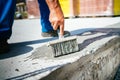 details of worker using brush for covering concrete basement with waterproof materials Royalty Free Stock Photo