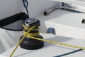 Details of yellow genoa sheet secured on self-tailing winch on sailing boat racer, boating concept Royalty Free Stock Photo