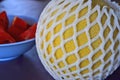 Yellow melon in white foam net protection Royalty Free Stock Photo