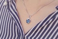 Detal of woman wearing a luxury pendant