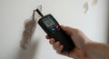 Detecting Moisture Damage: Using a Moisture Meter on a Damaged Wall Royalty Free Stock Photo