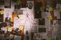 Detective board with fingerprints, photos, map and clues connected by red string Royalty Free Stock Photo