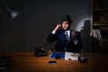 The detective sitting in dark room in vintage concept Royalty Free Stock Photo