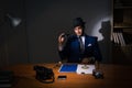The detective sitting in dark room in vintage concept Royalty Free Stock Photo