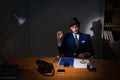 The detective sitting in dark room in vintage concept Royalty Free Stock Photo