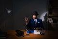 The detective sitting in dark room in vintage concept Royalty Free Stock Photo