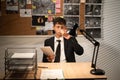 Detective working at desk in his office, drinking coffee and thinking of searching for solution Royalty Free Stock Photo