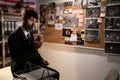 Detective working in his office interior with evidence board on wall, drinking coffee and searching for solution Royalty Free Stock Photo