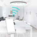 Detector alarm connect with smartphone on apartment background. 3D rendering Royalty Free Stock Photo