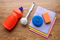 A set of colorful items and a detergent for the kitchen lie on the surface