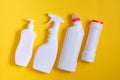 Detergent bottles isolated on yellow. Chemical cleaning supplies Royalty Free Stock Photo