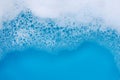 Detergent foam bubble on blue background. Top view Royalty Free Stock Photo