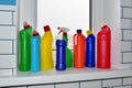 Detergent on the windowsill in the toilet against the background of white ceramic tiles. Detergents bottle. Household chemicals