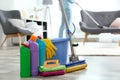 Detergents, bucket and mop on floor with janitor vacuuming carpet Royalty Free Stock Photo