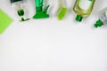 Detergents in plastic bottles. ÃÂ¡leaning accessories. Flat lay of green and white cleaning supplies on white background. Top view Royalty Free Stock Photo