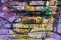 Deteriorated painted brick wall