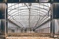 Deteriorated and weathered greenhouse metal structure by rural depopulation. Industry and agriculture background Royalty Free Stock Photo