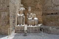 Deteriorating statue of the god Amun-Re and his wife Mut and a seated king just before the Colonnade Hall in Luxor Temple, Egypt. Royalty Free Stock Photo