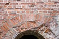 Deterioration in old brick masonry in arched doorway and wall Royalty Free Stock Photo