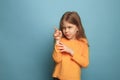 The determination. Teen girl on a blue background. Facial expressions and people emotions concept