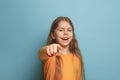 The determination. Teen girl on a blue background. Facial expressions and people emotions concept