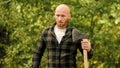 Determination of human spirit. Man checkered shirt use axe. Brutal male in forest. Power and strength. Lumberjack carry