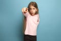 The determination. Teen girl on a blue background. Facial expressions and people emotions concept