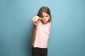 The determination. Teen girl on a blue background. Facial expressions and people emotions concept