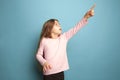 The determination. Teen girl on a blue background. Facial expressions and people emotions concept