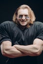 Determined American football player posing with painted face and chewing gum Royalty Free Stock Photo