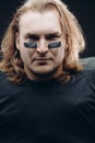 Determined American football player posing with painted face and chewing gum Royalty Free Stock Photo