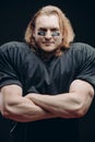 Determined American football player posing with painted face and chewing gum Royalty Free Stock Photo