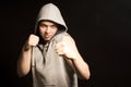 Determined angry young boxer in a hooded top