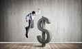 Determined banker man in empty concrete room breaking dollar figure