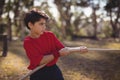 Determined boy practicing tug of war during obstacle course