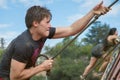 Determined climbing rope on obstacle course