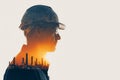 determined construction worker in hard hat, with double exposure effect showcasing industrial landscape. image conveys strength Royalty Free Stock Photo