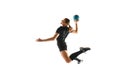 Determined female athlete practicing handball moves with concentration and dedication against white studio background Royalty Free Stock Photo