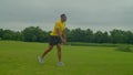 Determined fit African man practicing plyometric jumping lunges outdoors