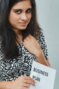 Business-oriented Indian woman, floral dress, intense gaze Royalty Free Stock Photo